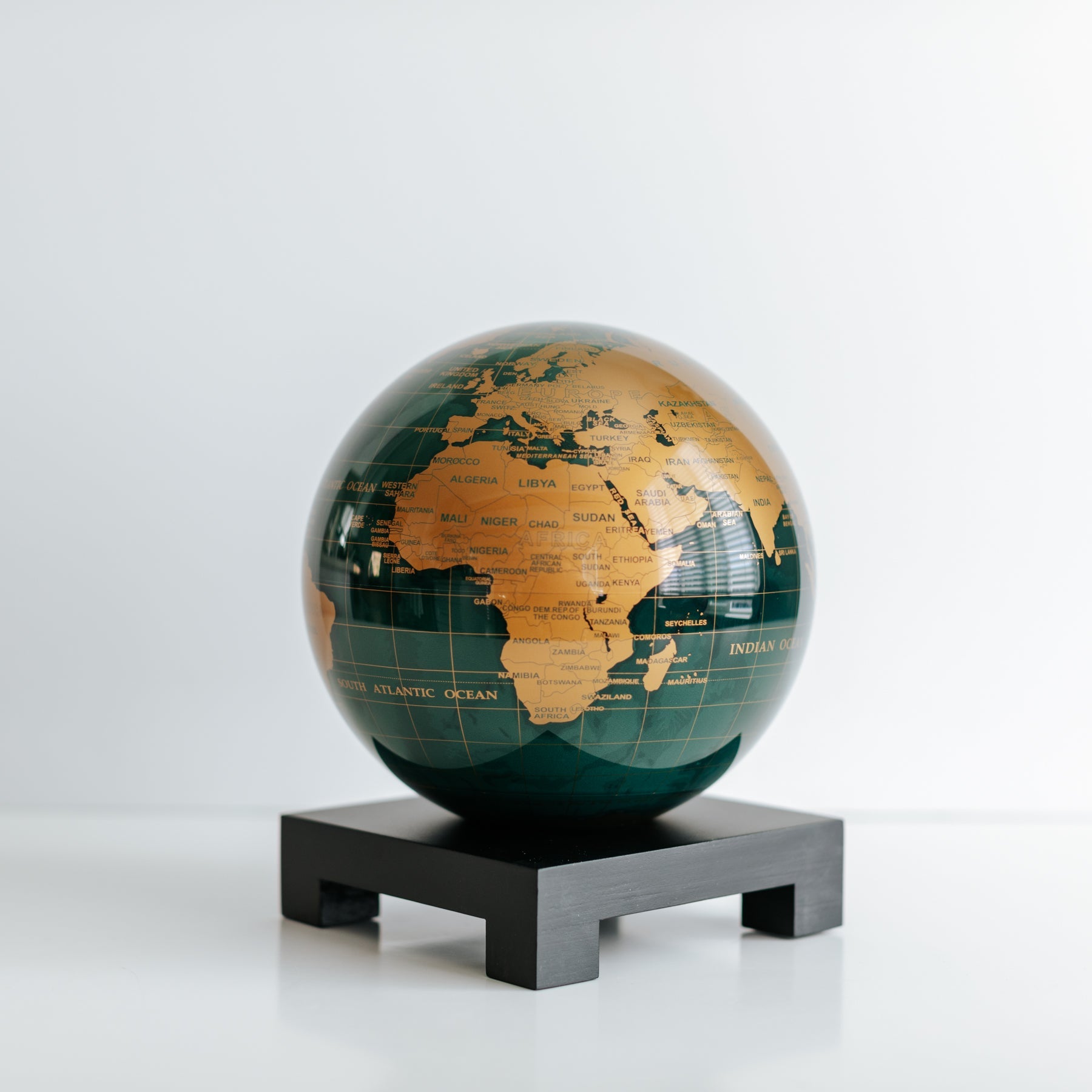 Green and Gold MOVA Globe on black square base, modern art decor and unique luxury gift for globe enthusiasts