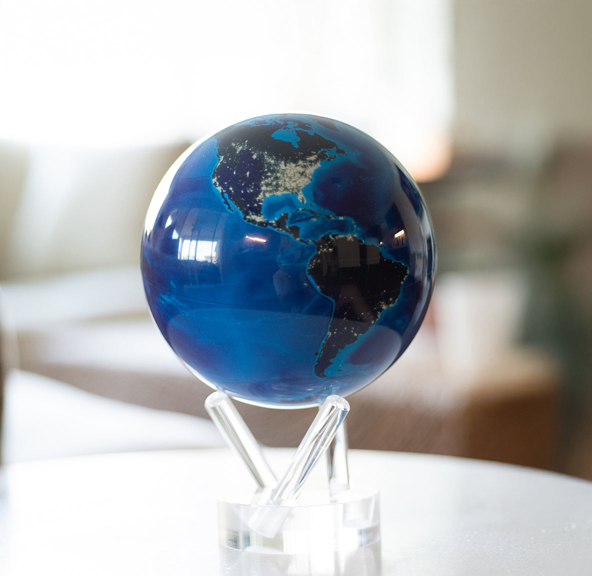 Earth at Night MOVA Globe showcasing illuminated city lights in a modern living room setting