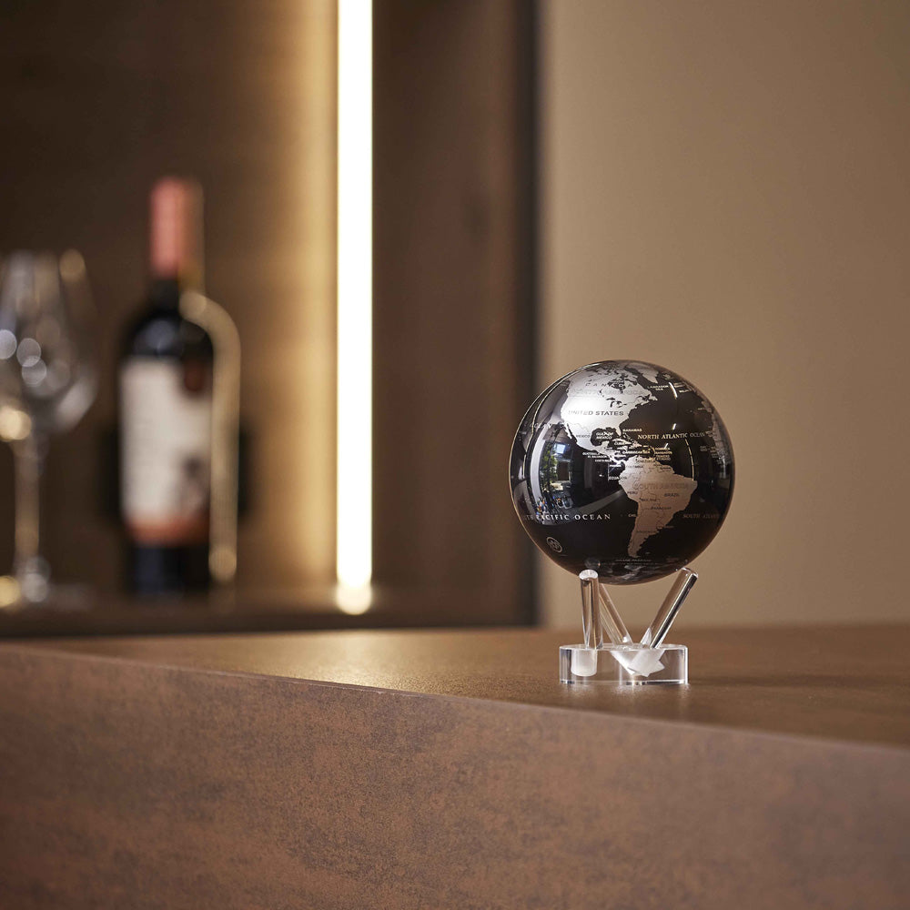 Jet Black & Silver MOVA Globe displayed on countertop with acrylic base