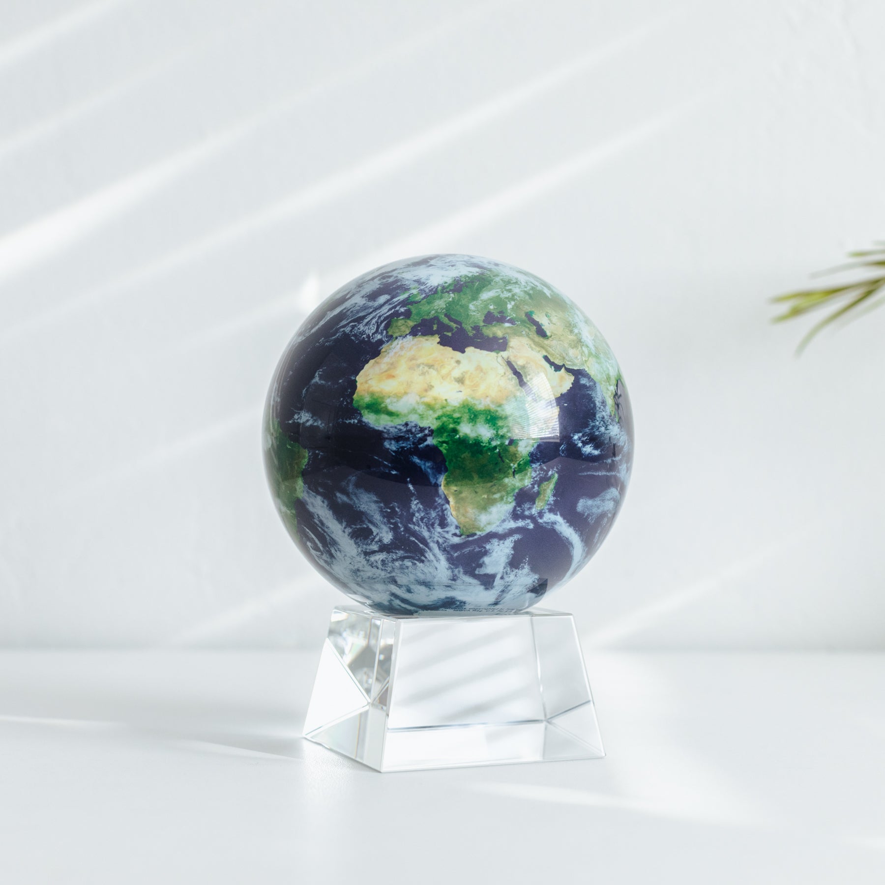 Close-up of Earth with Clouds MOVA Globe on crystal base, modern office decor