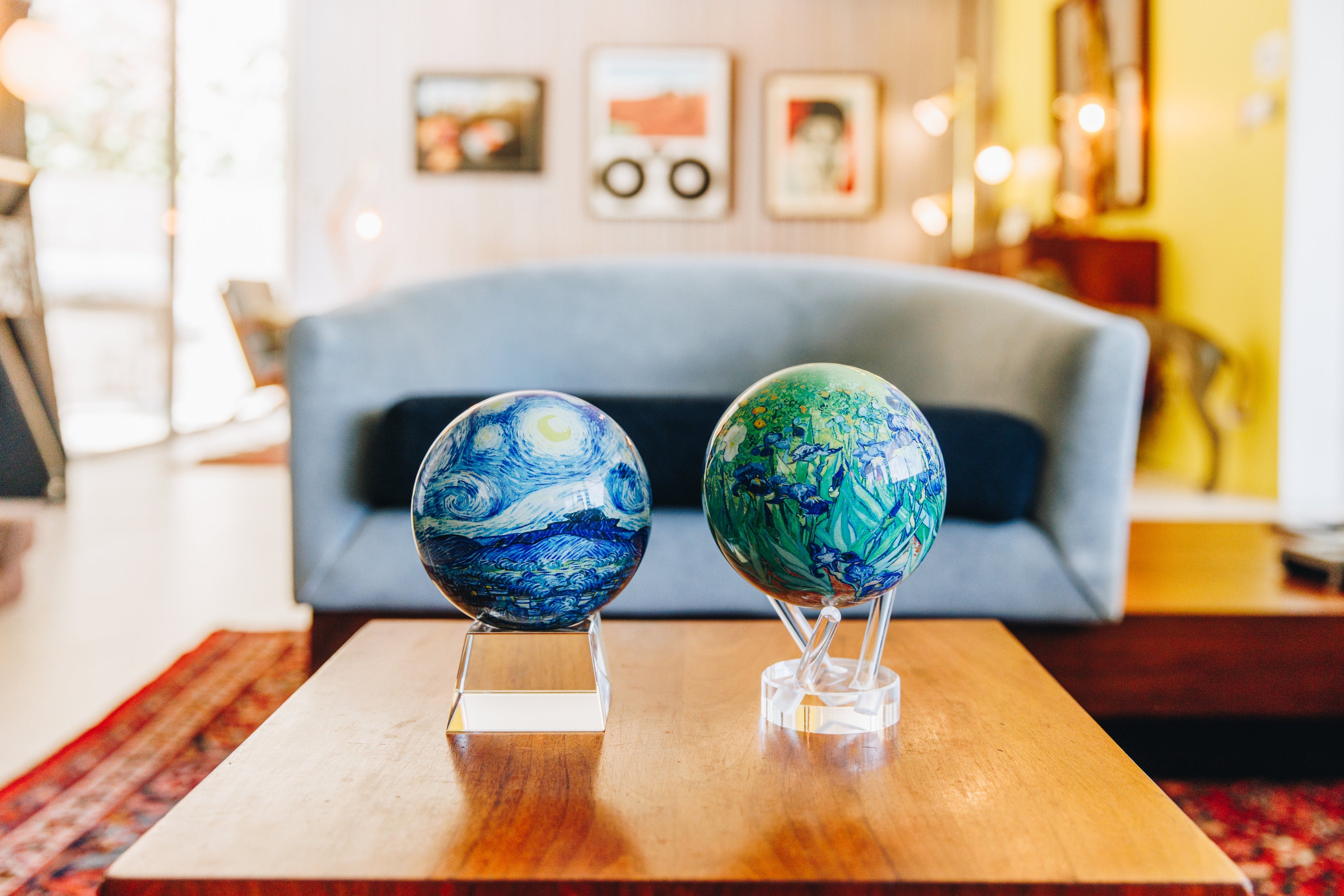 Van Gogh Starry Night and Irises MOVA globes on a modern coffee table in a cozy living room