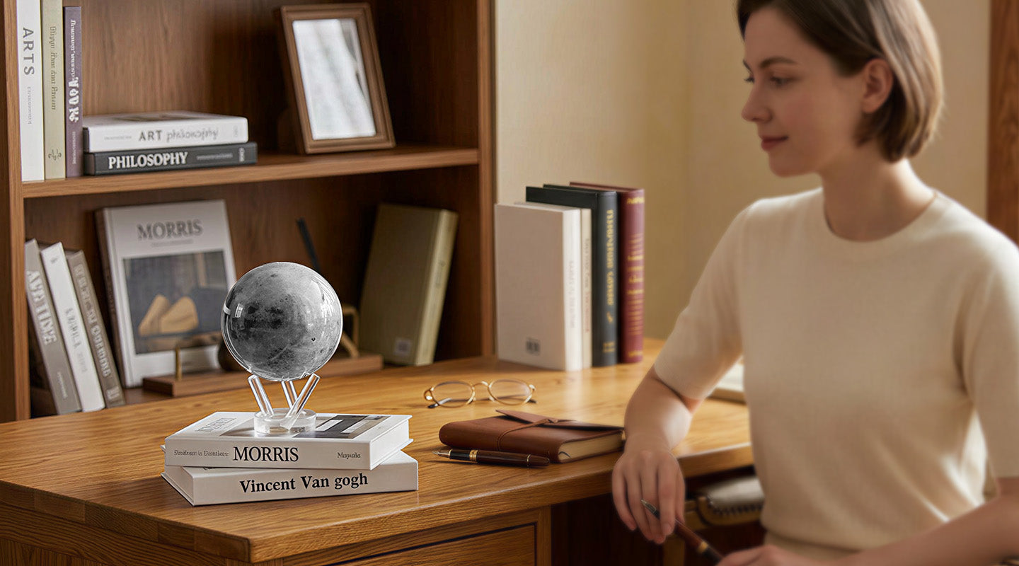 MOVA Moon globe with acrylic base on books in a cozy wooden study room with modern home office decor