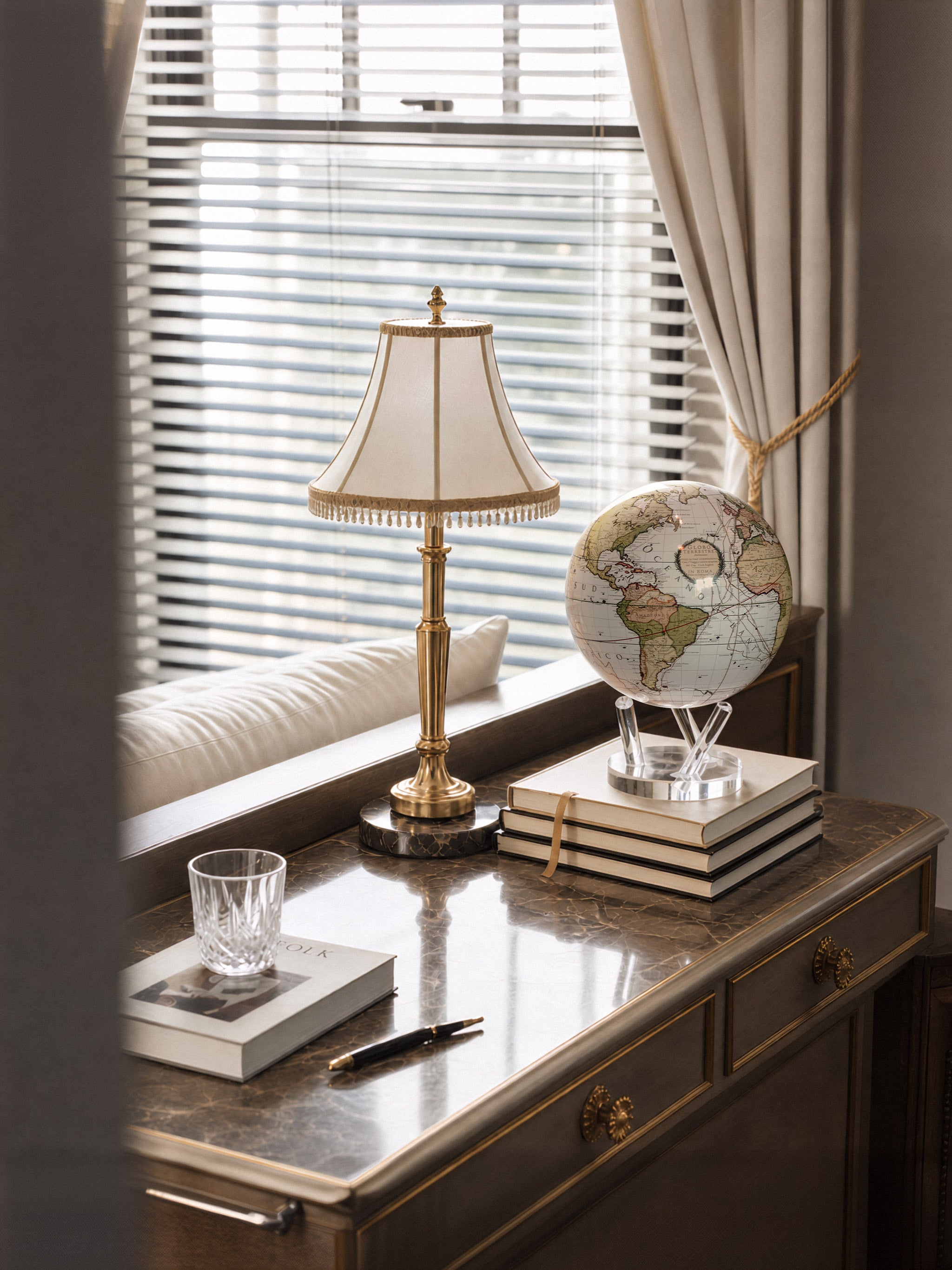 Antique Cassini white map MOVA globe styled on a luxury writing desk with elegant traditional home decor accents