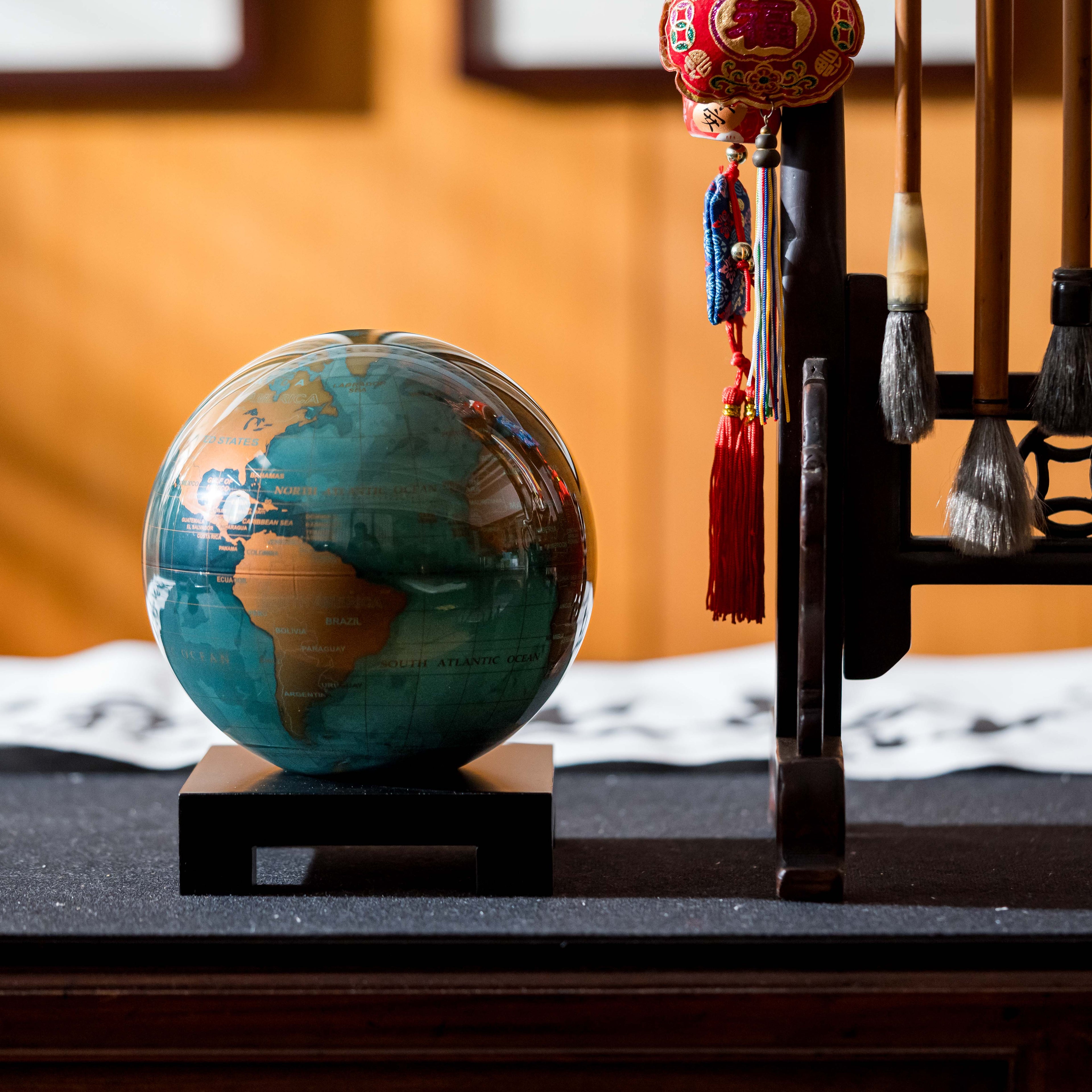 Blue and Gold MOVA rotating globe with gold accents, elegant home decoration and thoughtful travel gift