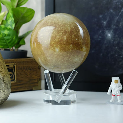 Mercury MOVA Globe beside plant and astronaut figurine desk decor