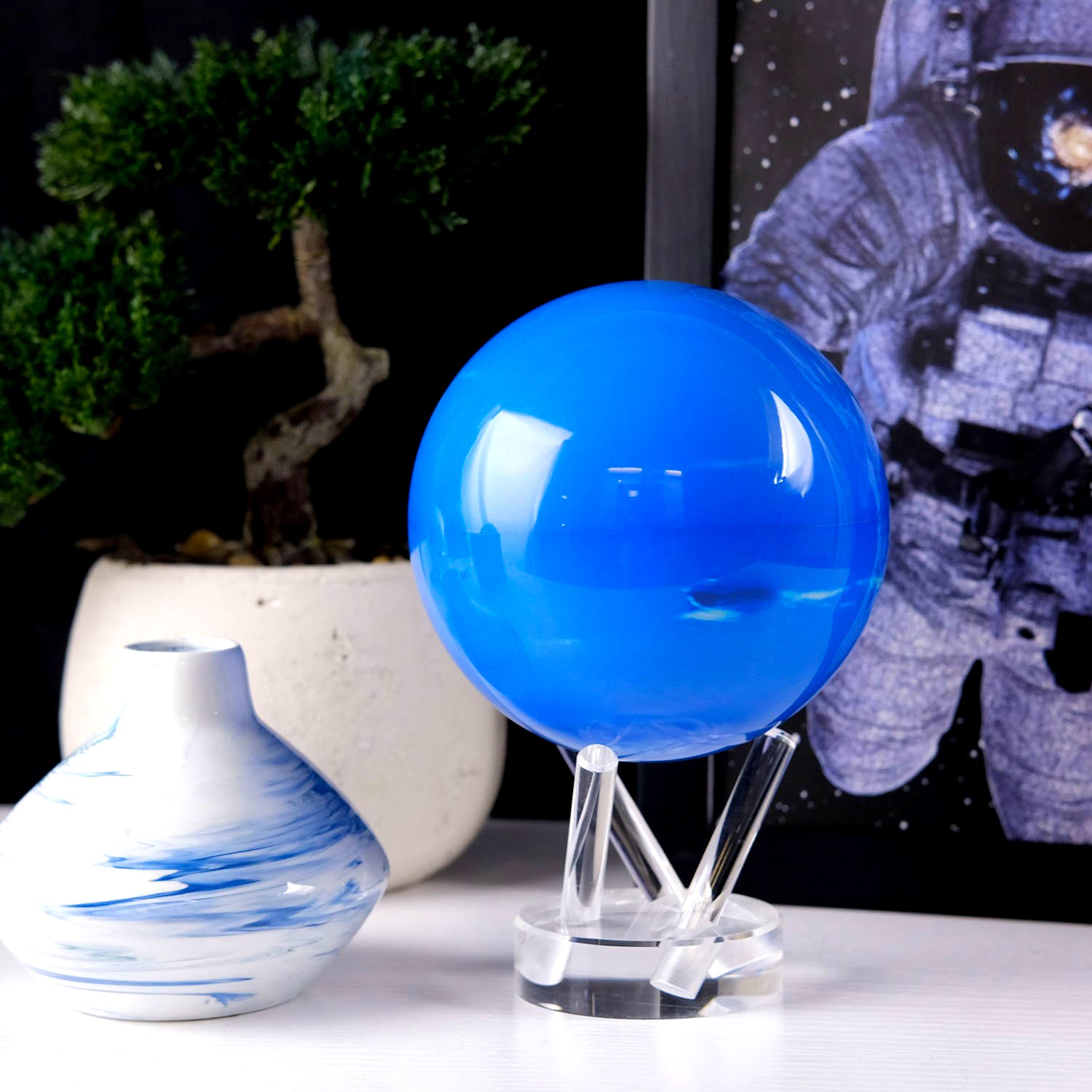 Neptune MOVA Globe displayed beside decorative vase and framed artwork