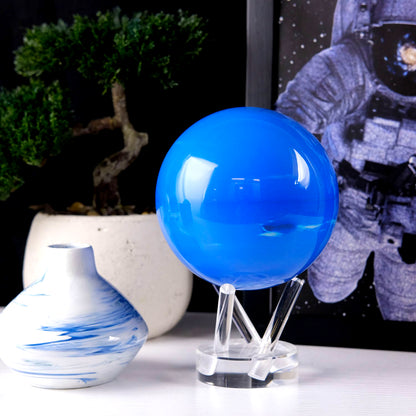 Neptune MOVA Globe displayed beside decorative vase and framed artwork