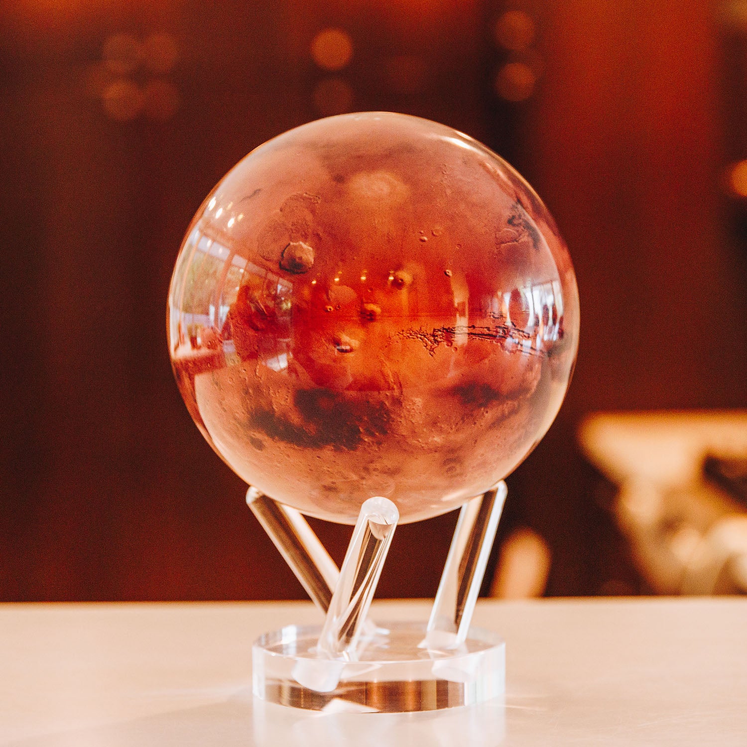 Mars-inspired MOVA globe displayed on clear acrylic base