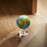 Ocean Blue Relief Map MOVA Globe displayed on hardwood floor with acrylic base