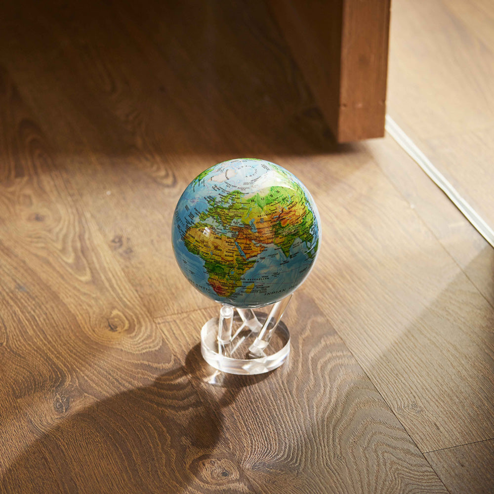Ocean Blue Relief Map MOVA Globe displayed on hardwood floor with acrylic base