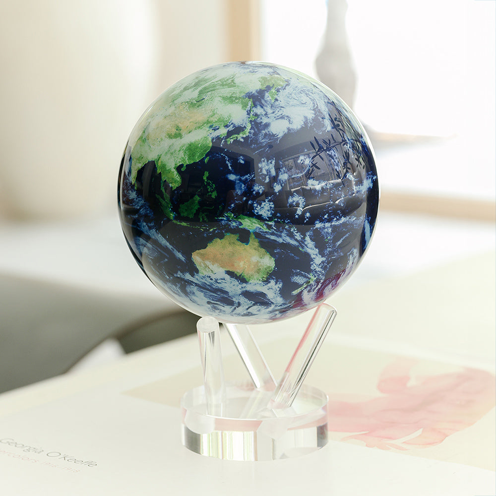 Earth with Clouds MOVA globe on an acrylic base displayed in a bright modern home setting