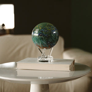 Van Gogh Irises MOVA globe displayed on acrylic base in a cozy modern living room with artistic decor styling