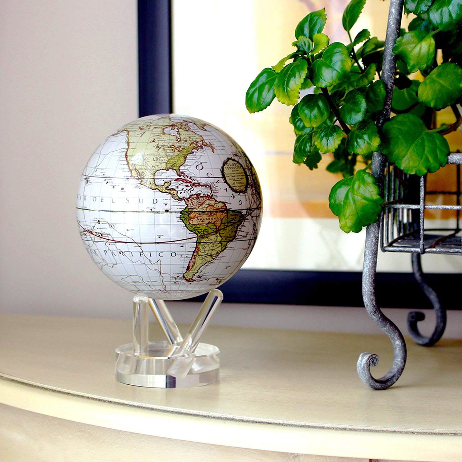 Antique Cassini White MOVA Globe styled beside a green houseplant in a bright room