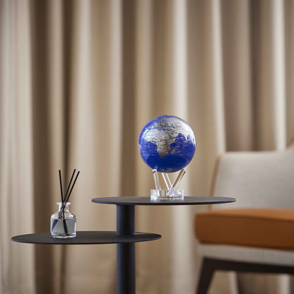Royal Blue &amp; Silver MOVA Globe on a side table with neutral décor and soft curtains