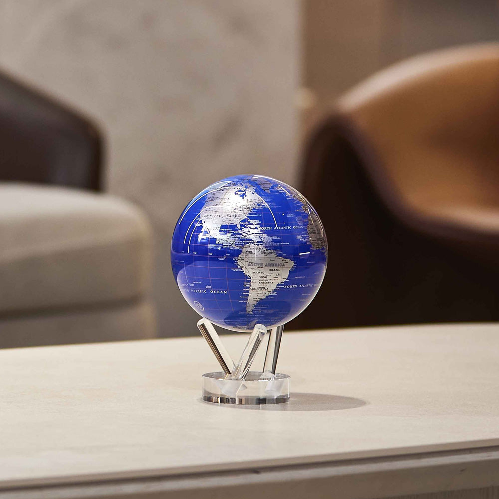 Royal Blue &amp; Silver MOVA Globe displayed on a coffee table in a modern living room