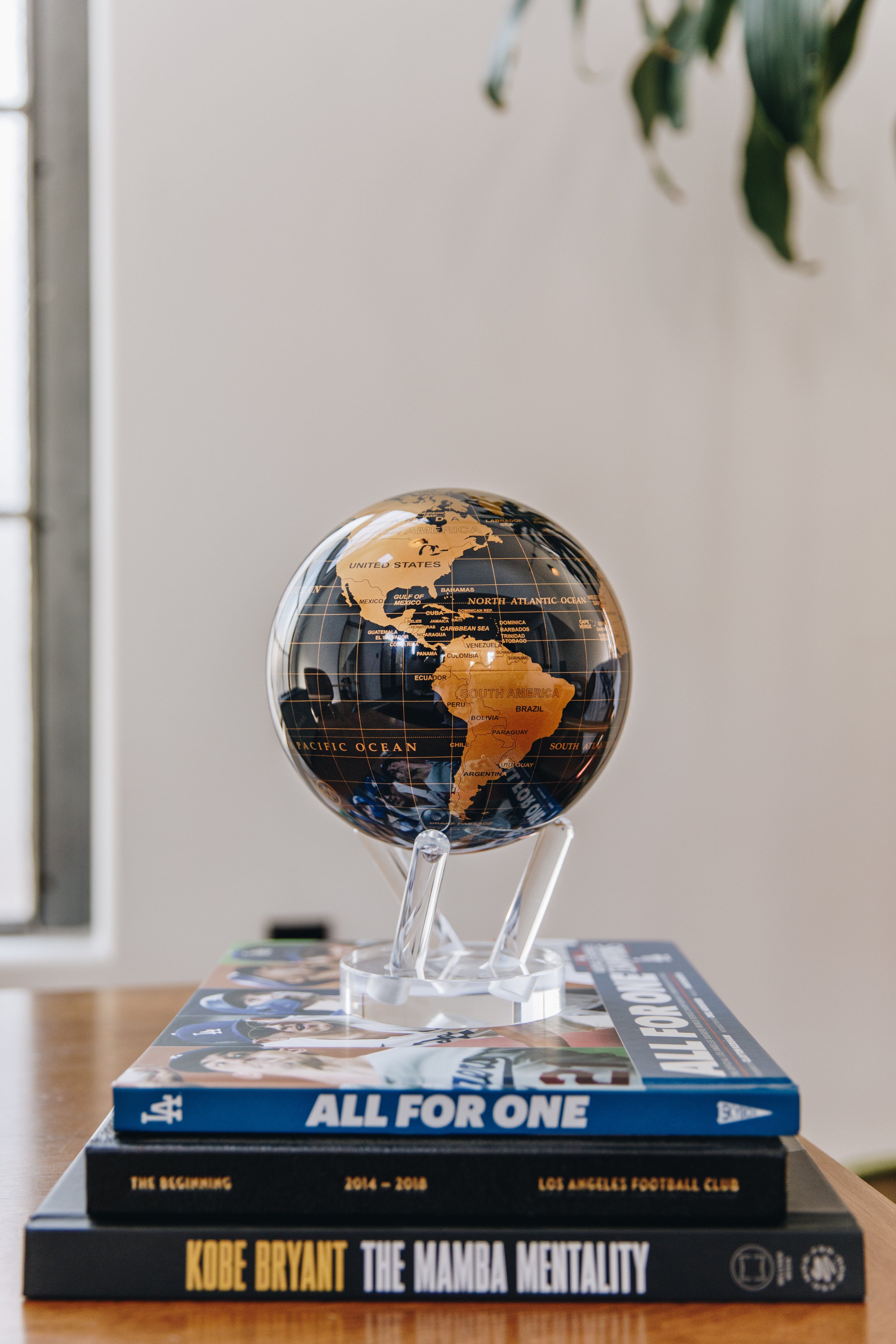 Black and gold MOVA globe designed for refined modern interiors