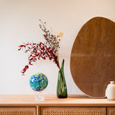 Van Gogh Irises MOVA Globe beside a vase and mirror, adding colorful gallery-inspired style