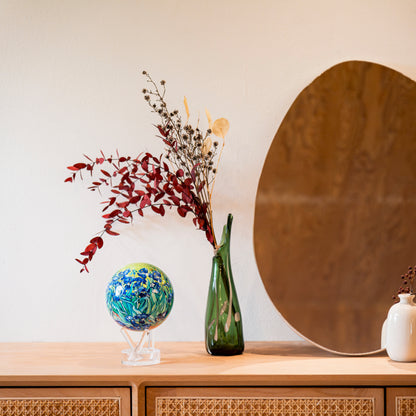 Van Gogh Irises MOVA Globe beside a vase and mirror, adding colorful gallery-inspired style