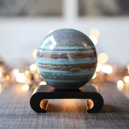 MOVA Jupiter globe on black curved stand with warm lighting, stylish astronomy-themed home decor