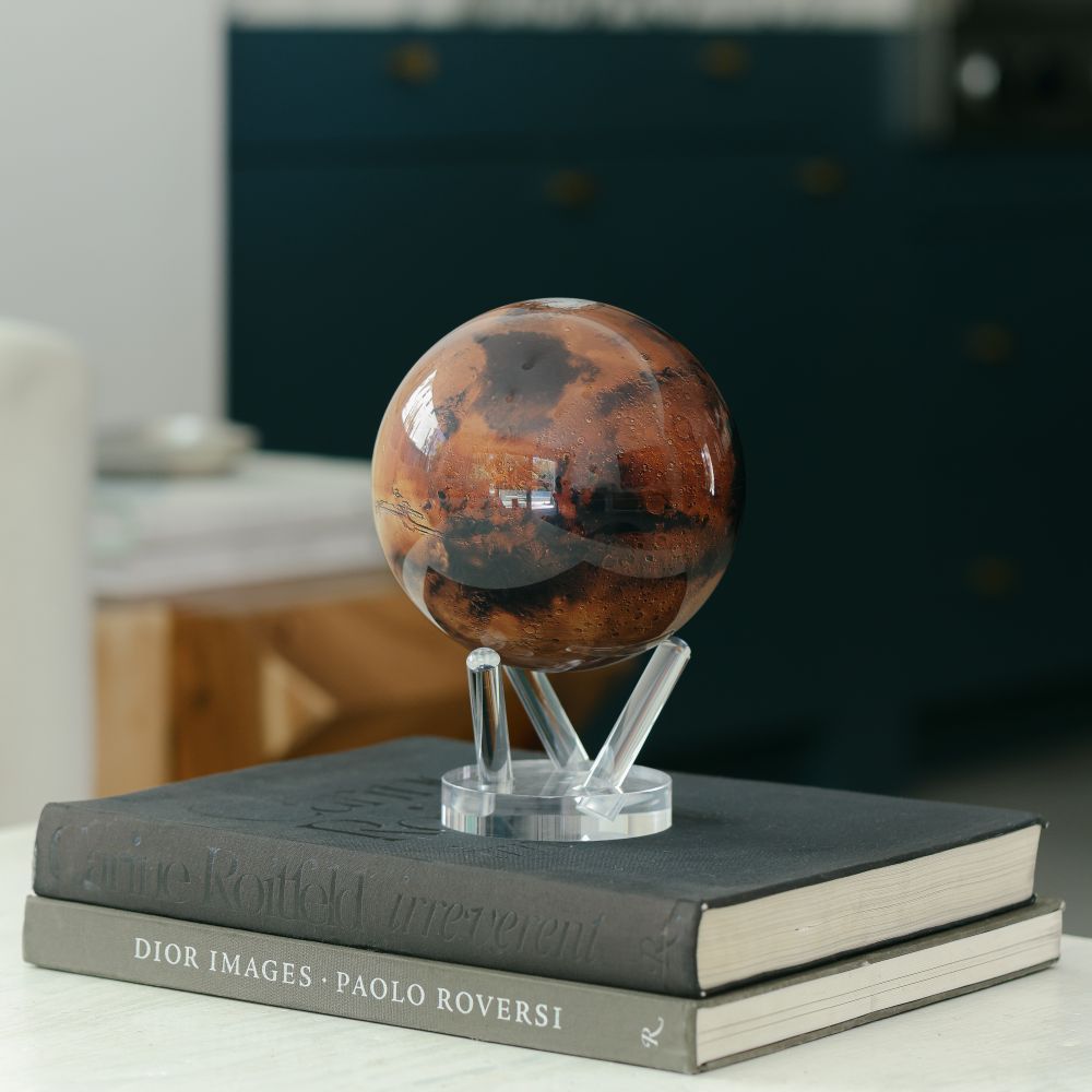 Mars MOVA Globe displayed on stacked books with acrylic base