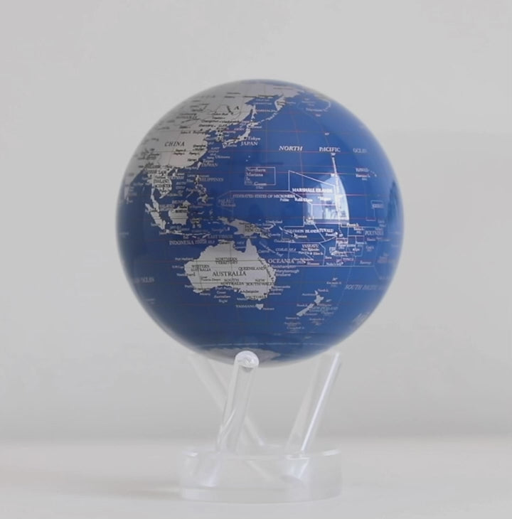 Royal Blue and silver MOVA globe rotating smoothly on acrylic base in celestial themed display video