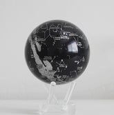 Black constellation MOVA globe rotating on acrylic base in celestial product showcase video