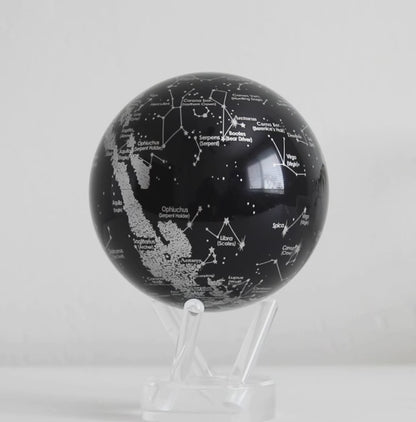 Black constellation MOVA globe rotating on acrylic base in celestial product showcase video
