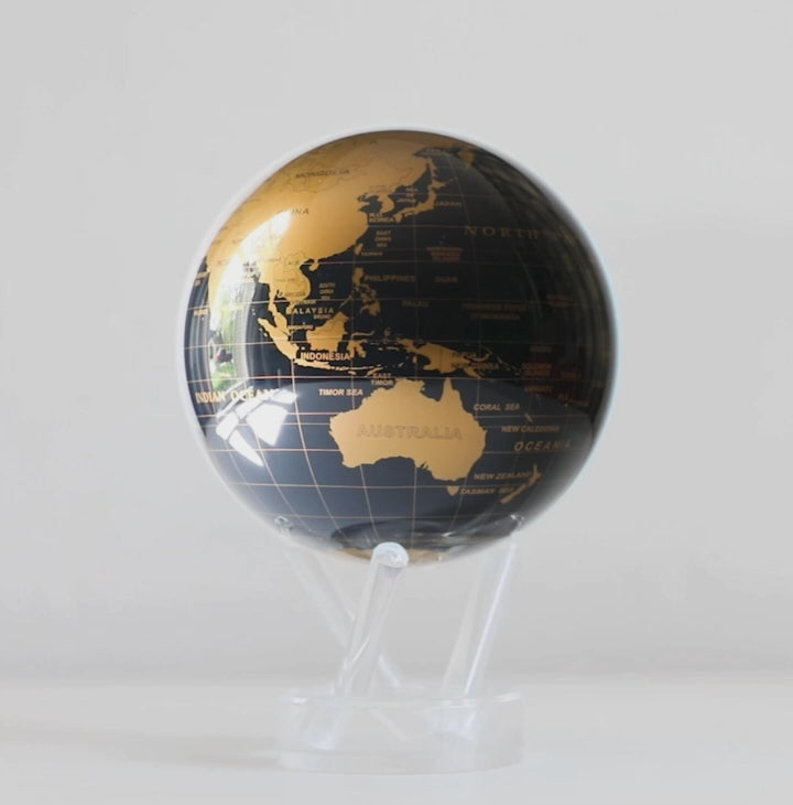 Jet Black and gold MOVA globe rotating on acrylic base in luxury product showcase video