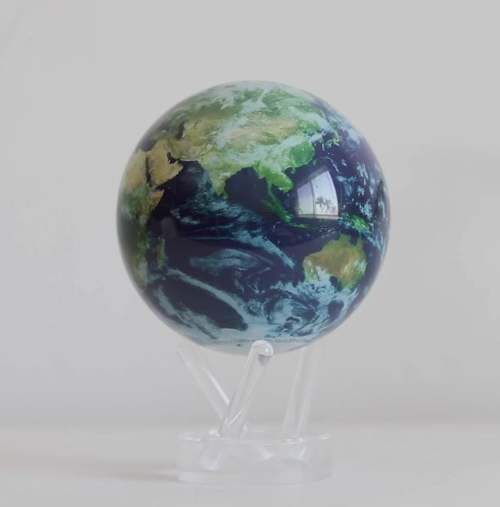 Earth at Night MOVA globe rotating on acrylic base in illuminated world map display video