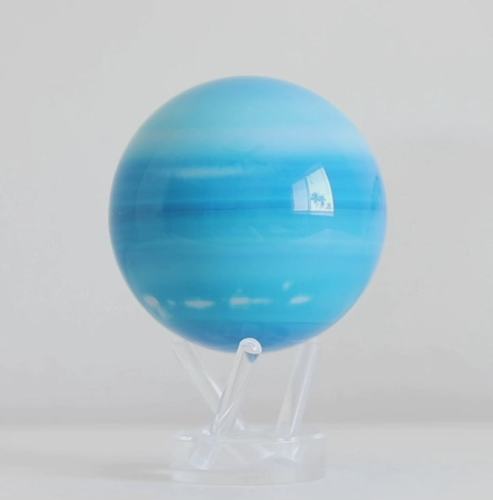 Uranus MOVA globe rotating on acrylic base in planetary themed product showcase video