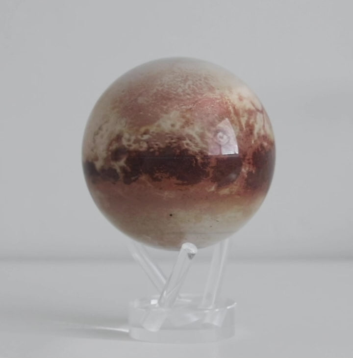 Pluto MOVA globe rotating smoothly on acrylic base in space themed product video