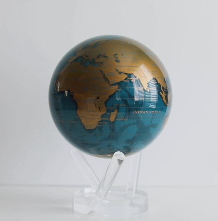 Cerulean Blue and gold MOVA globe rotating smoothly on acrylic base in product showcase video