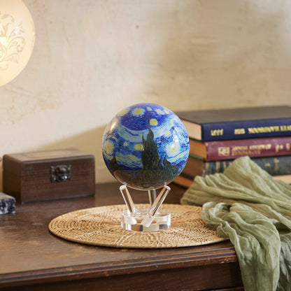Van Gogh Starry Night MOVA Globe displayed on a wooden table with books and warm decor