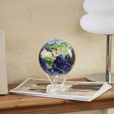 Earth with Clouds MOVA Globe on console table with magazines