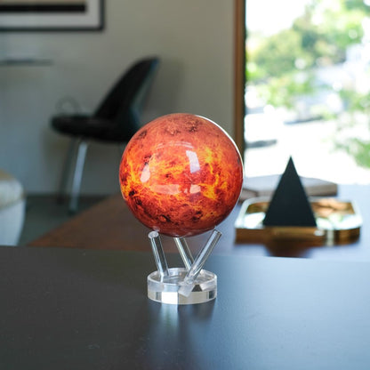 Venus MOVA Globe with fiery red NASA imagery on a desk near a sunlit window