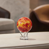 Venus MOVA Globe on acrylic base displayed on a tabletop in a modern living room