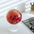 venus MOVA globe with acrylic base styled on a modern desk in a bright minimalist workspace