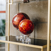 Venus MOVA Globe reflected on a glass shelf in a contemporary home interior